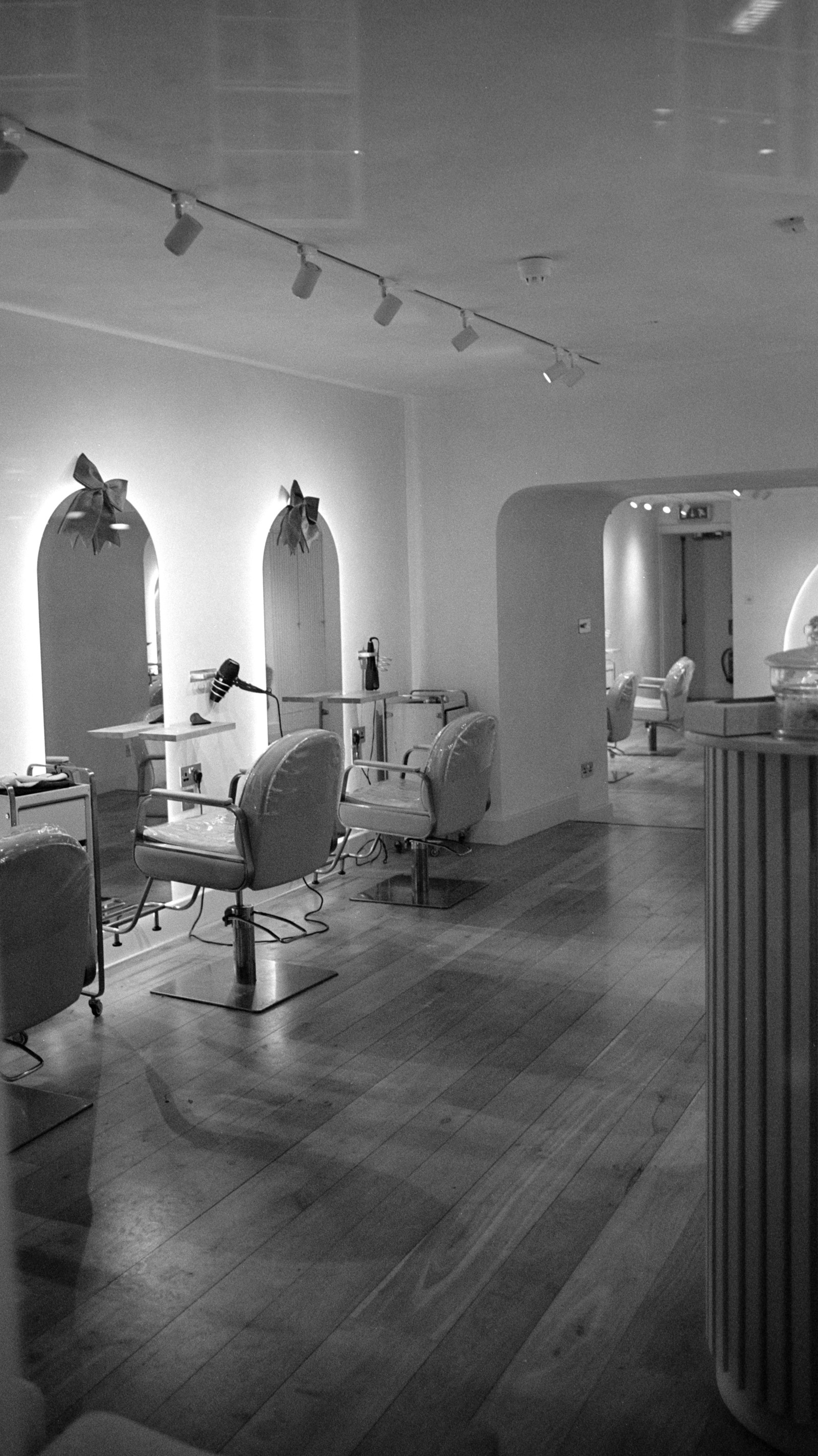 Contemporary salon with sculptural mirrors and styling chairs, used for a salon concept